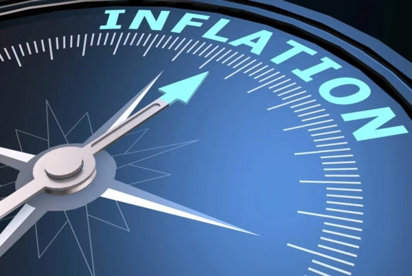 A compass that's pointing to the word inflation.