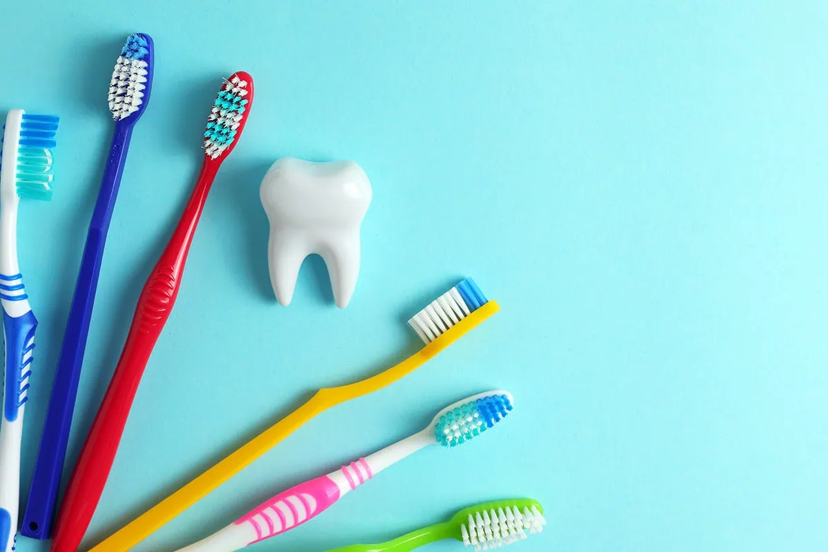 Bundled Brilliance: How Medicare Advantage Simplifies Your Healthcare Suitcase 3 several toothbrushes and a large plastic tooth.