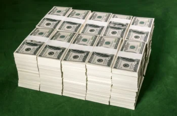 many stacks of dollar bills are stacked on top of one another in a cube.
