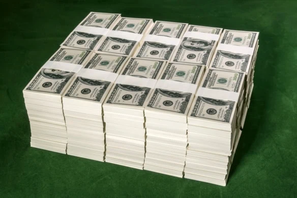 many stacks of dollar bills are stacked on top of one another in a cube.