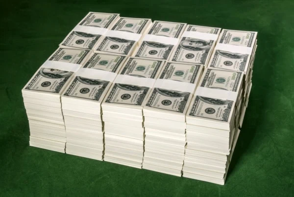 many stacks of dollar bills are stacked on top of one another in a cube.