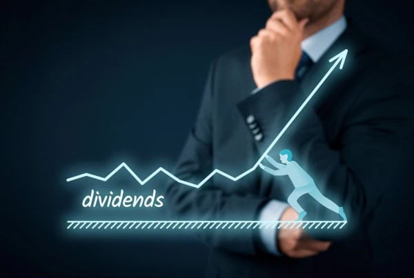 a hologram of a charge showing dividend rising superimposed against a thinking businessman.