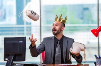 a businessman wearing a kings crown juggles little cloth bags of cash.