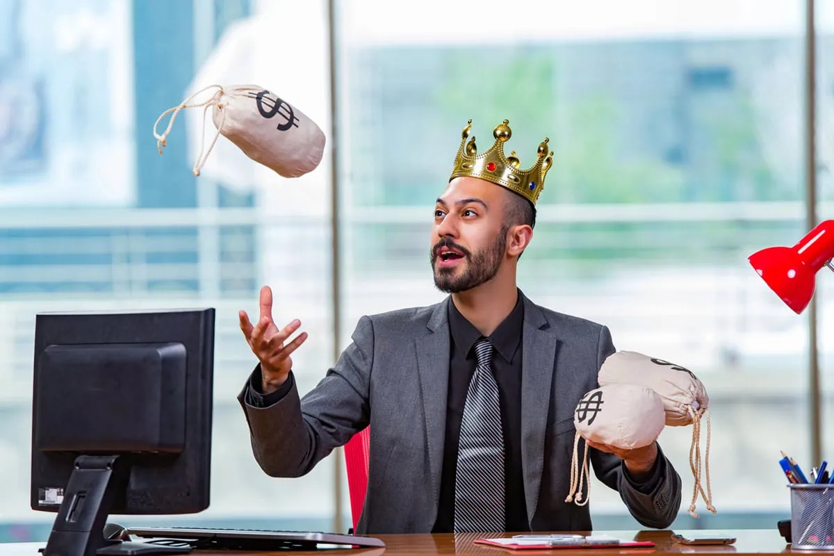 15 "Kings" Boasting Up to 70 Years of Nonstop Dividend Growth 2 a businessman wearing a kings crown juggles little cloth bags of cash.