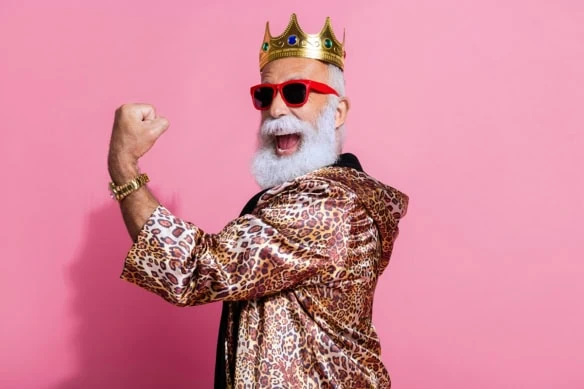 an old man dressed in a leopard-pattern robe and a gold crown.