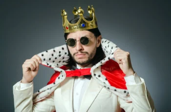 a man is dressed up both like a businessman and a king.