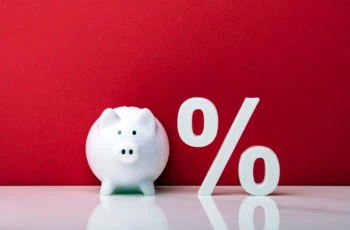 a piggy bank next to a percent sign.