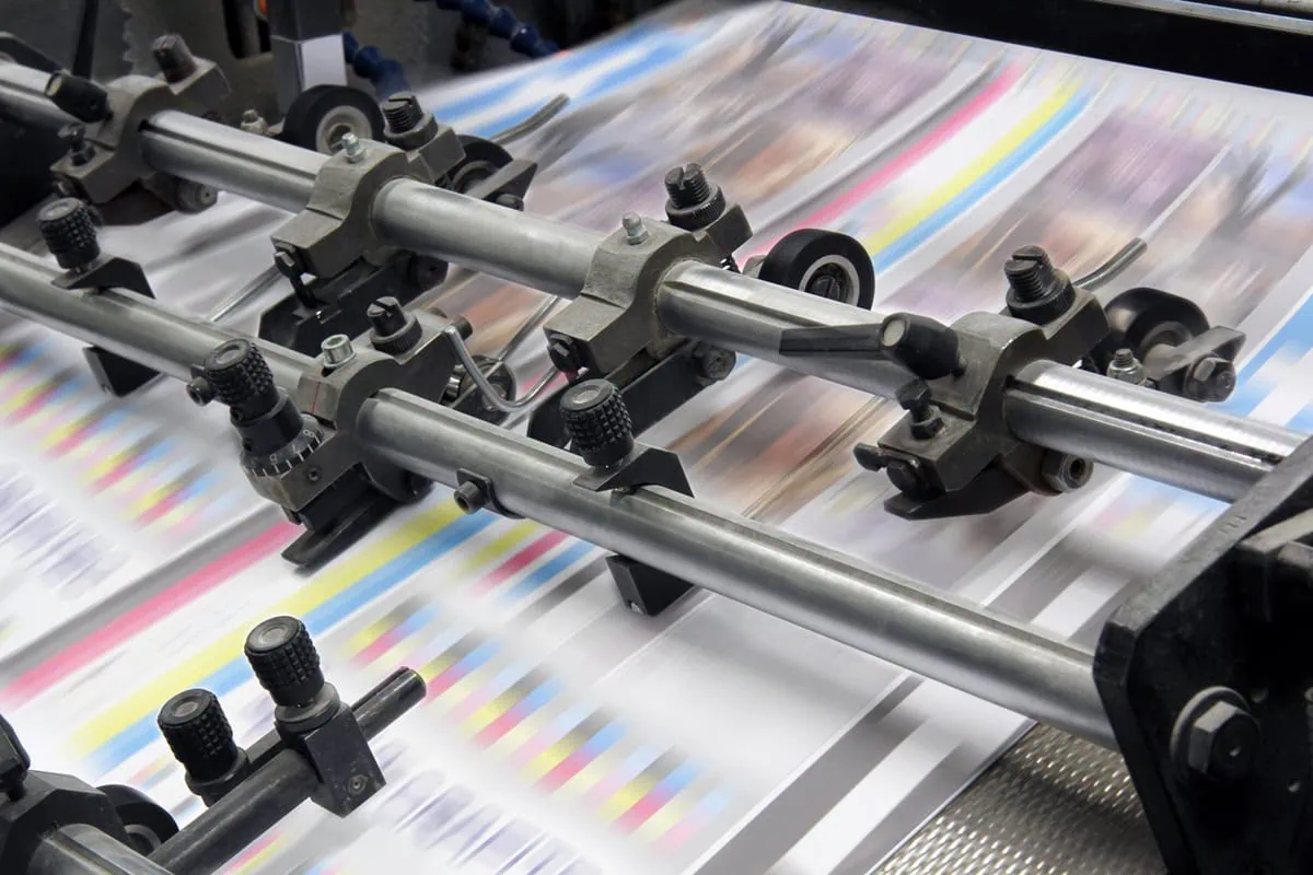 pages speed through an industrial printer.