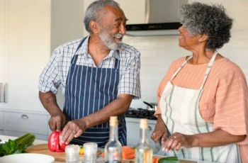 elderly couple cooking together in the kitchen