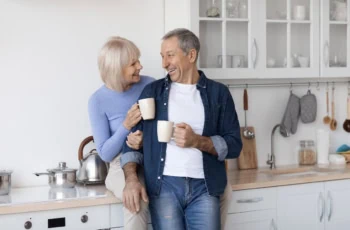 Cheerful elderly spouses enjoying time together, drinking coffee