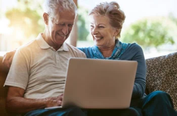 Keeping up with modern times. a happy senior couple using a laptop together on the sofa at home.