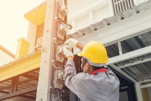 electrician installing power meters power lines