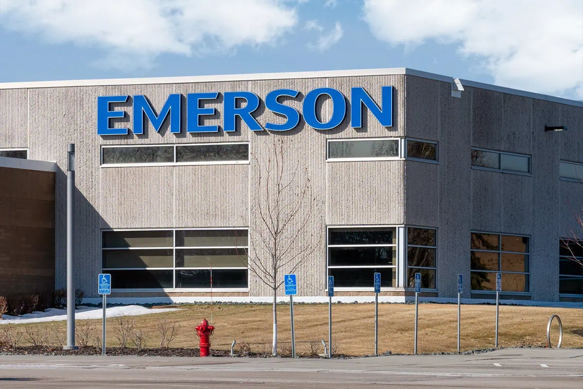 The 50-Year Club: 14 Dividend Stocks With Decades of Payout Growth 14 Emerson Electic manufacturing facility and trademark logo.
