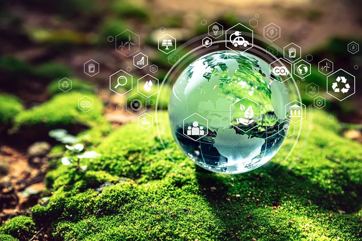 Crystal globe on moss with environment icons, representing e s g.