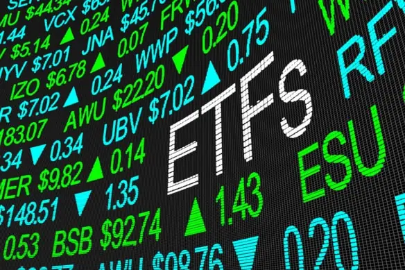a stock tickerboard with the word ETFs spelled out in larger lettering than the rest.