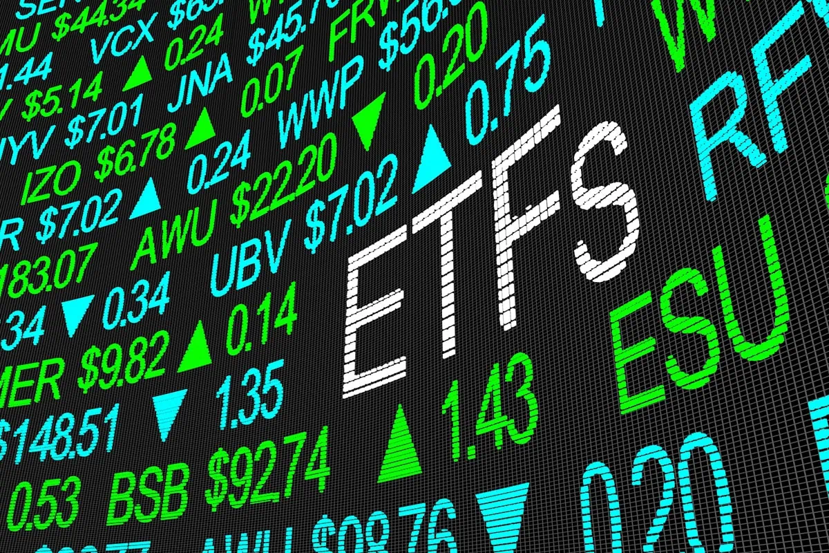 Sweet Schwab Savings: 9 ETFs That Charge Pennies Per Year 2 a stock tickerboard with the word ETFs spelled out in larger lettering than the rest.