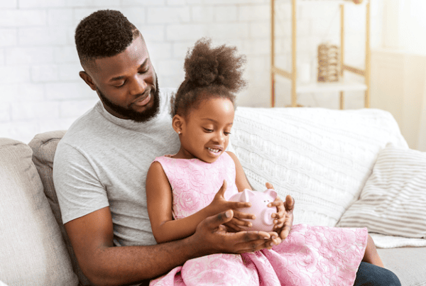 father daughter child piggy bank savings
