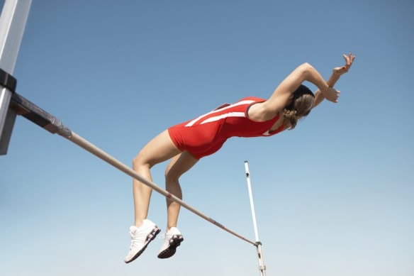 female jumping over a high bar-1200