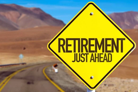 a yellow street sign that says retirement just ahead.