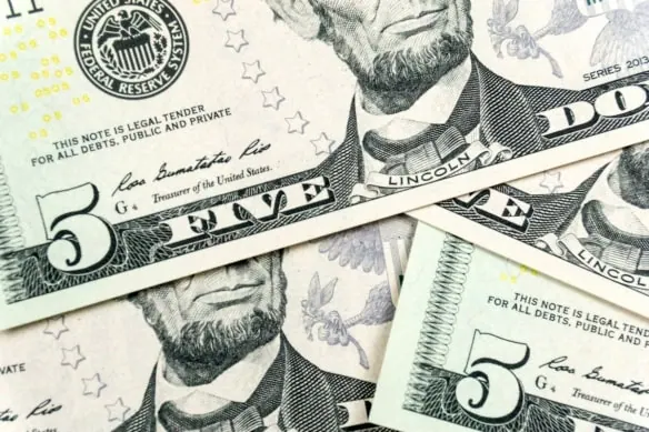 five-dollar bills scattered.