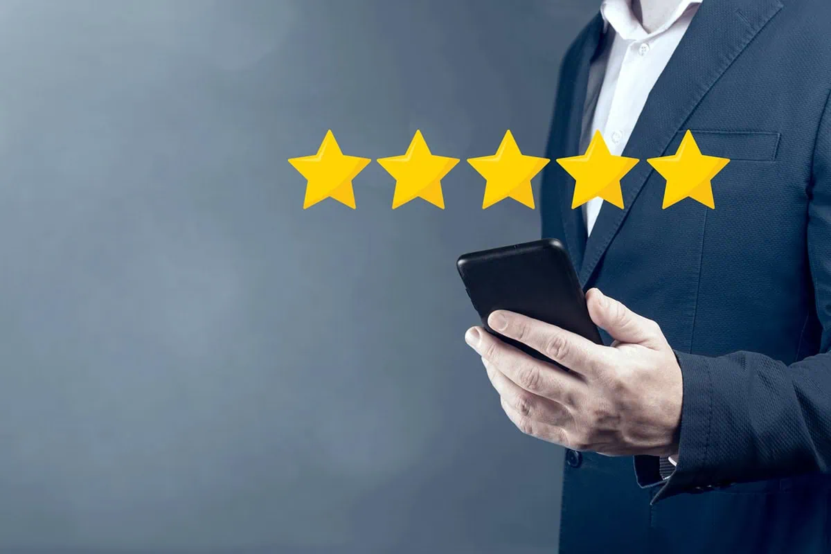 a man is looking at a phone while a five-star rating hovers over it.