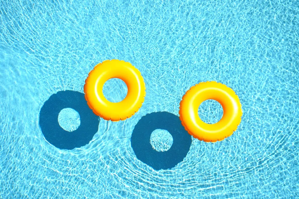 two yellow inner tubes floating in water.