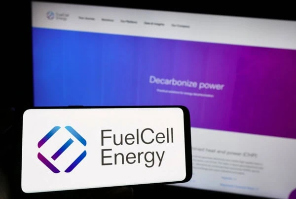 the fuelcell energy logo on a smartphone and a laptop.