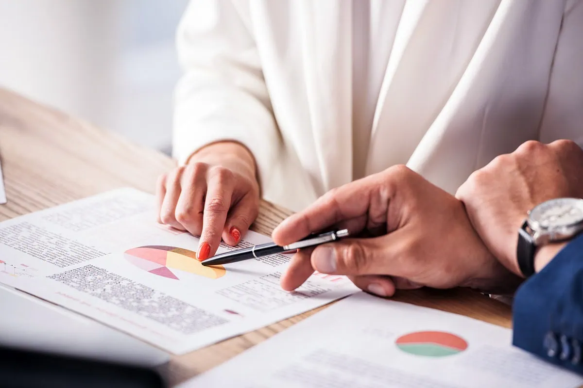 wealth managers look over charts.