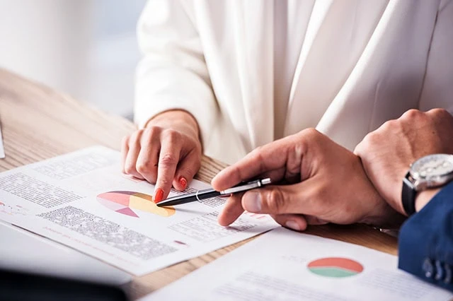 wealth managers look over charts.