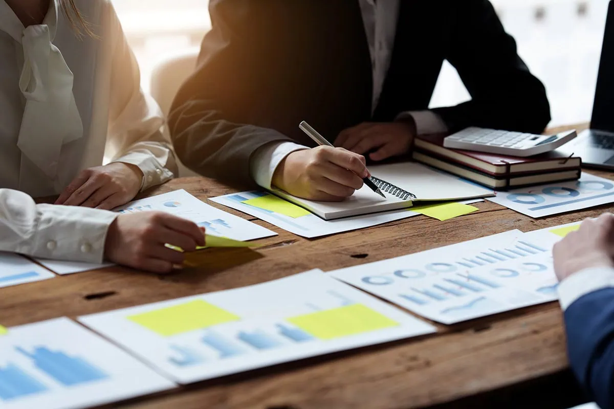 wealth managers look over charts.