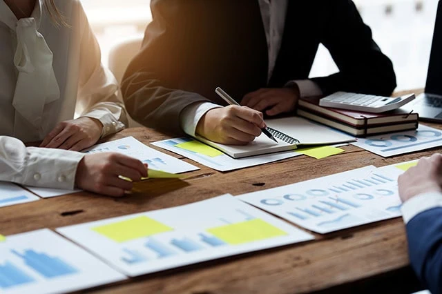 wealth managers look over charts.
