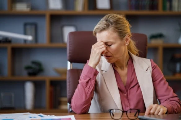 Gen X woman at desk disappointed stressed