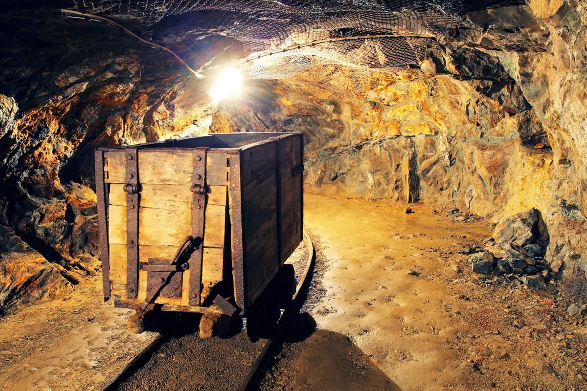 These 7 Gold ETFs Are Soaring as Gold Eclipses $4,000 9 a gold mining cart inside of a gold mine.