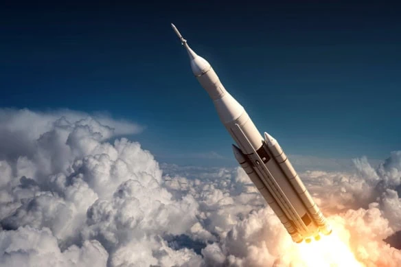 a rocket surges above the clouds and into space.