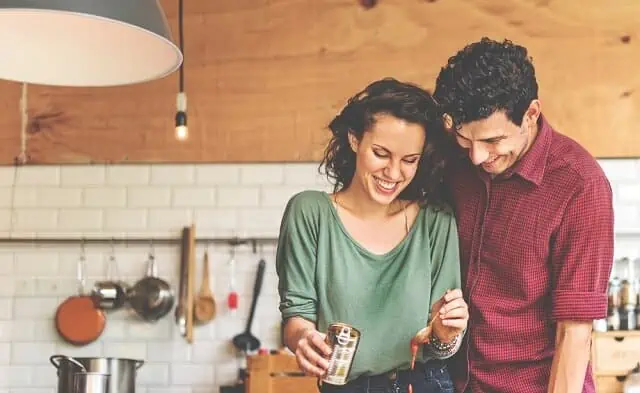 happy couple cooking dinner together