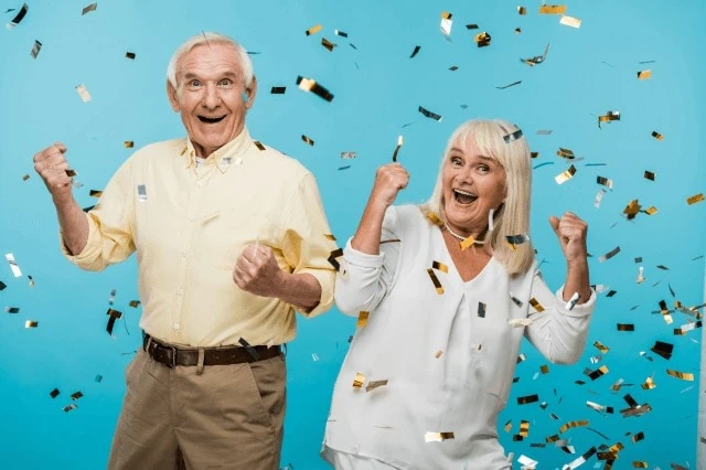 happy seniors elderly couple celebrating