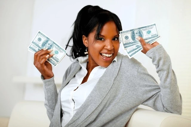 happy woman holding cash money