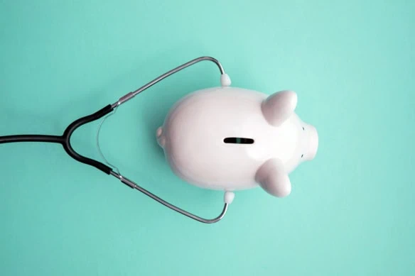 piggy bank with stethoscope.