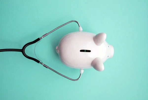 piggy bank with stethoscope.