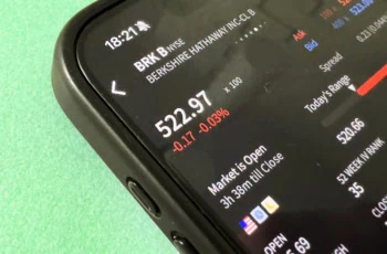A smartphone investing app shows a quote for Berkshire Hathaway stock.
