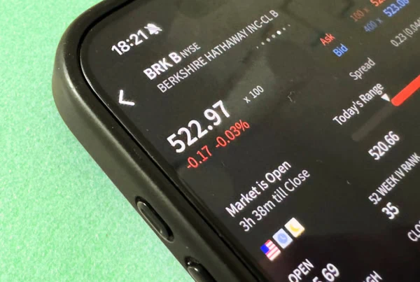 A smartphone investing app shows a quote for Berkshire Hathaway stock.