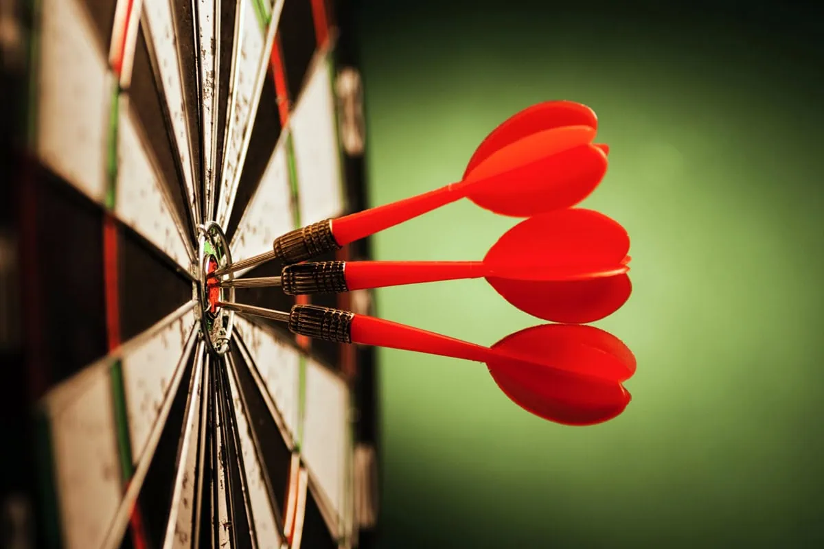 Maximize Your IRA With These 7 Schwab Retirement Funds 10 three darts in the bullseye of a target.