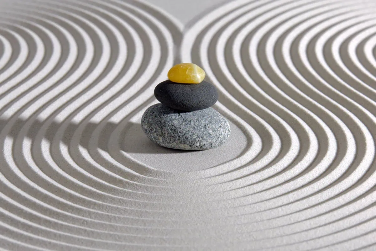 8 Low-Volatility ETFs Shielding Investors From Market Jitters in 2026 4 a japanese zen garden with stacked stones in raked sand.