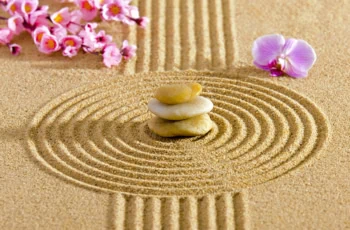 a japanese zen guarden with stacked rocks and lotus blossoms.