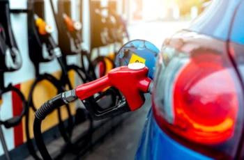a red gas pump pouring gasoline into a blue car's gas tank.