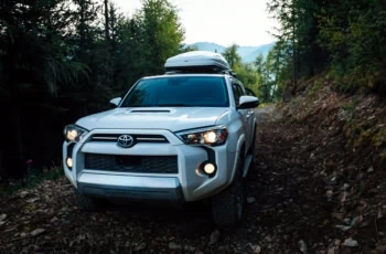 a toyota SUV with roof cargo.