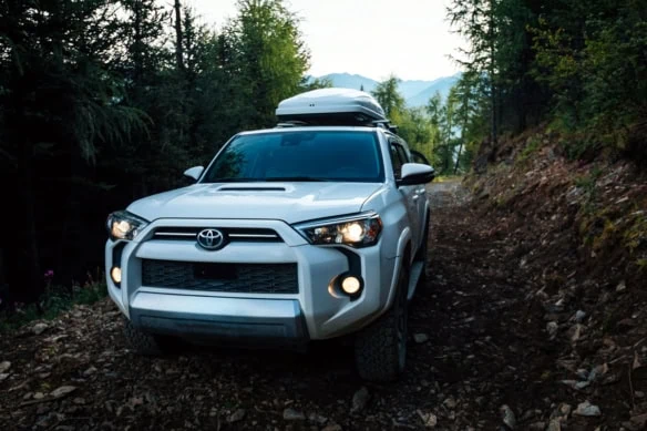a toyota SUV with roof cargo.