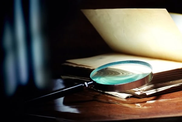 a magnifying glass on a book.