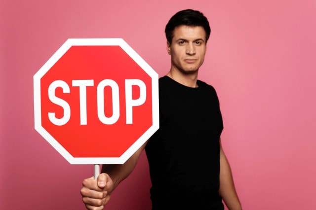 man holding stop sign