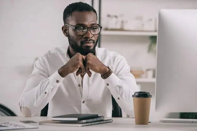 man looking at computer evaluating